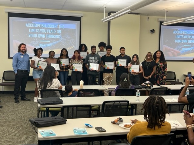 High school students pose with certificates at a graduation ceremony for CareerSource Brevard's 2023 Summer Jobs program. 